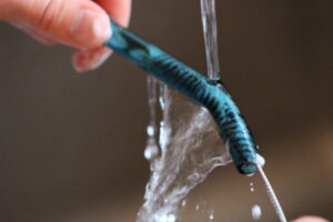 Cleaning a Glass Straw with a Brush